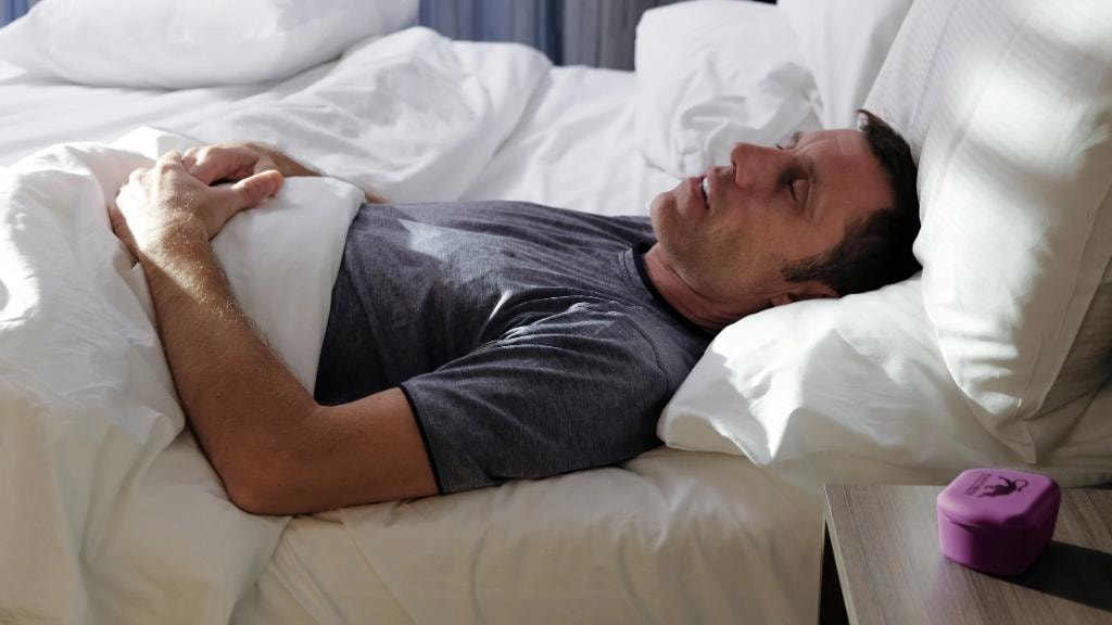 Man sleeping comfortably while wearing an oral appliance